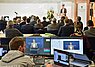 Monitore vor Publikum und einem Redner
